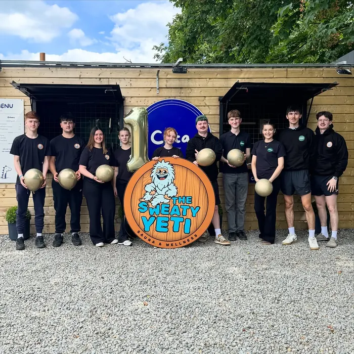 The Sweaty Yeti team outside the sauna with balloons for the first birthday.
