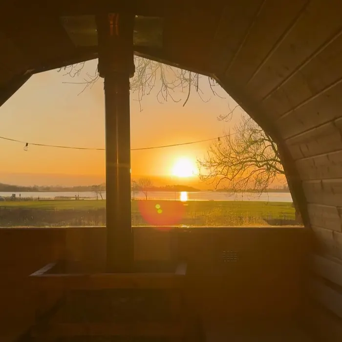 Sunrise over the water, seen through the open sauna doorway.